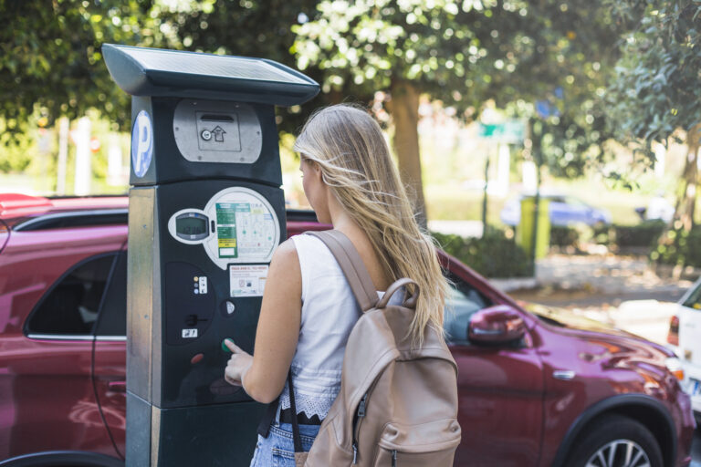 A motorist at a parking payment machine in Cambridge